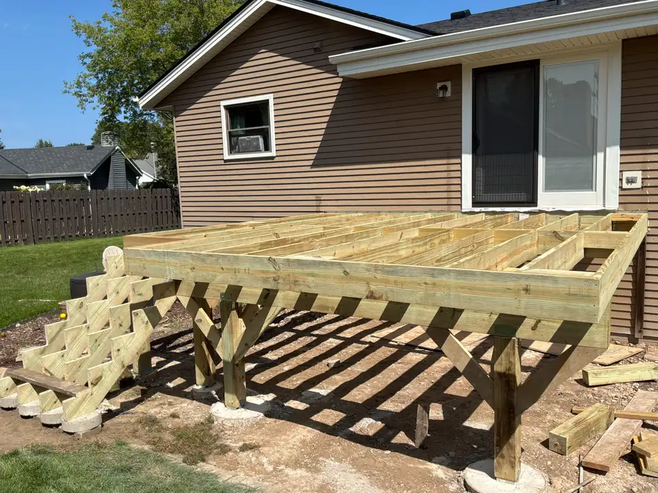 New framing: Pressure-treated beams, joists and stair stringers built level and square.