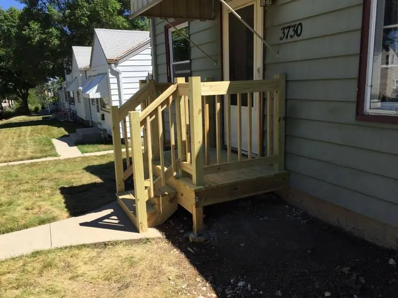 Porch stairs and railing in pressure-treated lumber