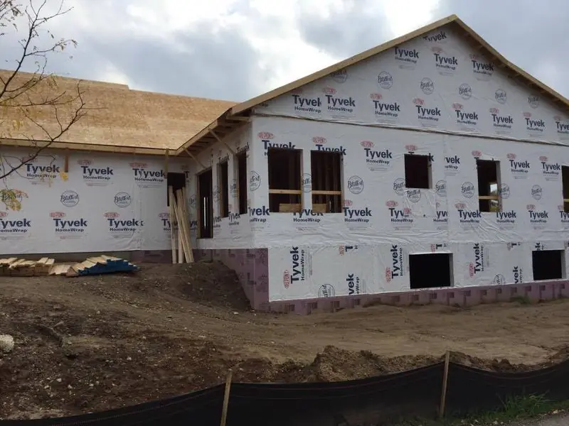 L-shaped ranch home framed and wrapped
