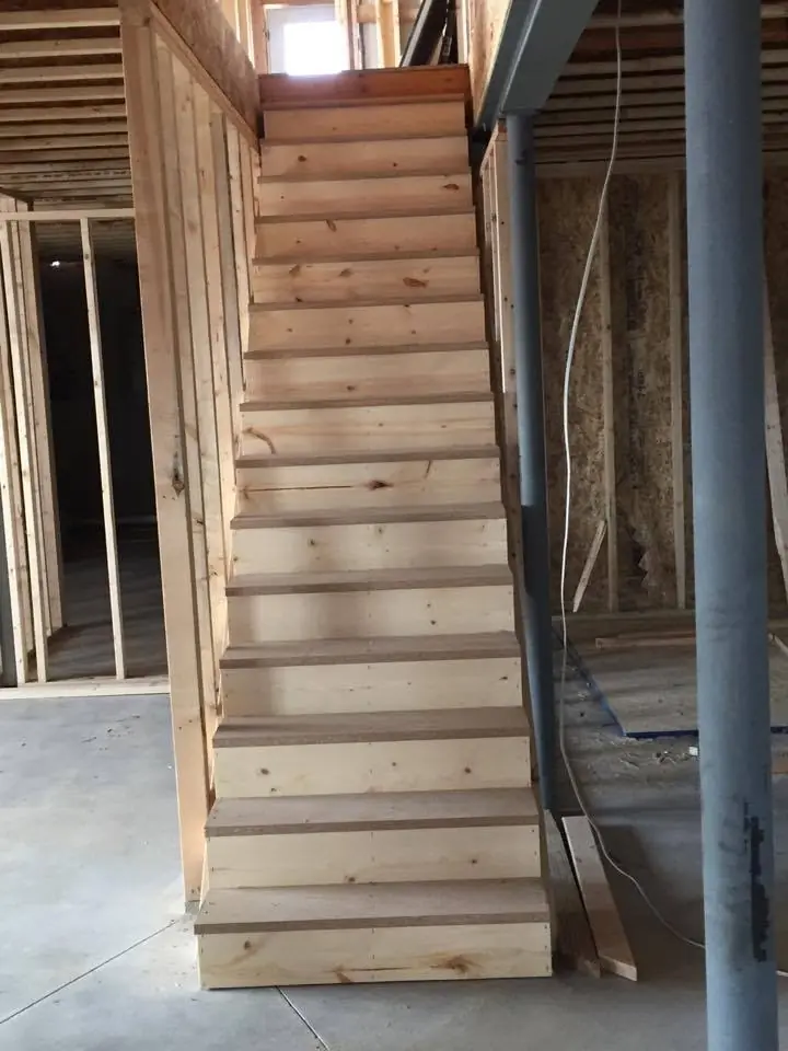 Basement stairway framed between stud walls