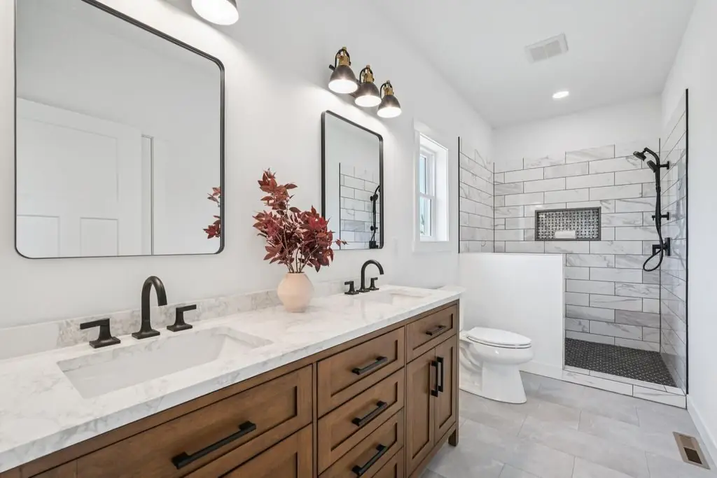 Bathroom with a wood double vanity and a tiled walk-in shower