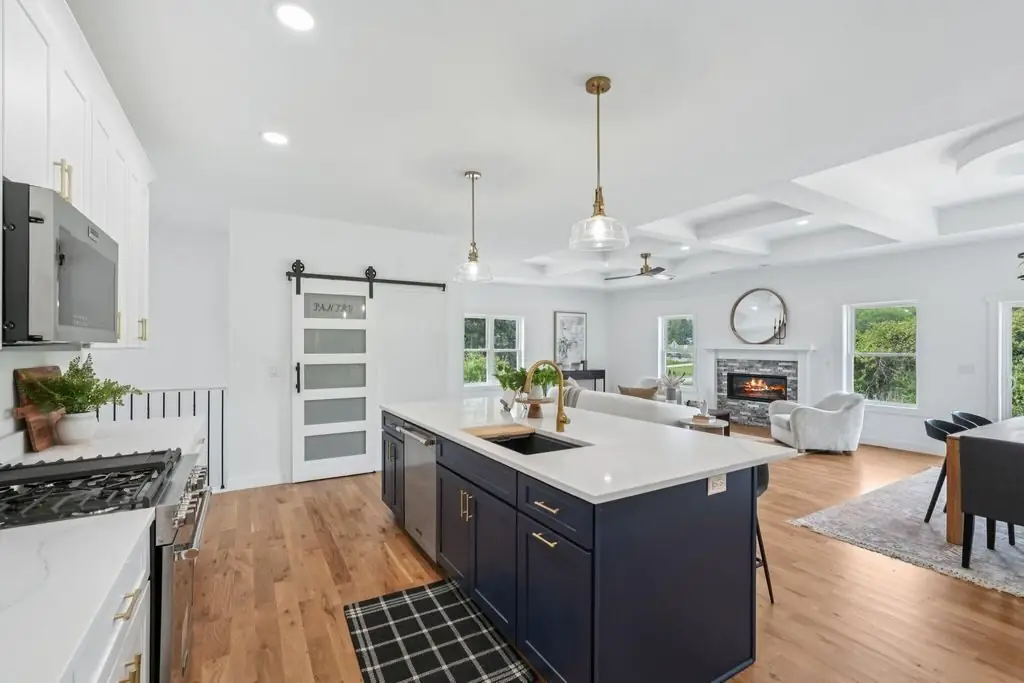 Kitchen looking through to the living room under a coffered ceiling