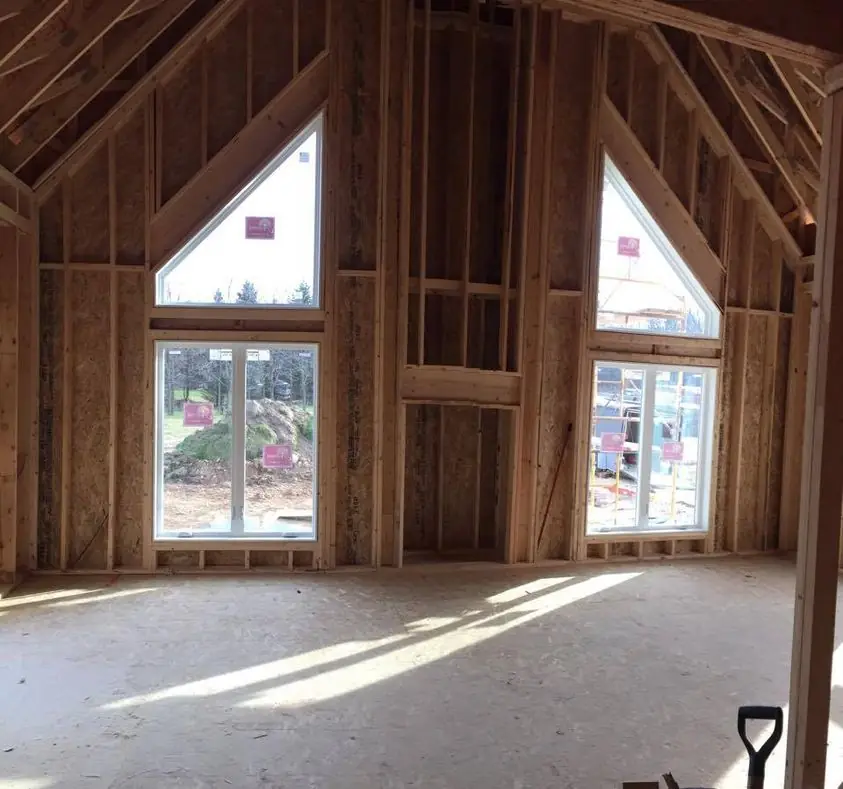 Vaulted great room with tall gable windows